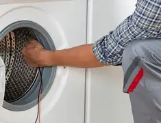 Dryer repair technician diagnosing and servicing a clothes dryer in New Haven, CT