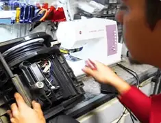 Vacuum repair technician servicing internal components on a workbench in New Haven, CT