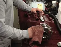 Vacuum repair technician cleaning and servicing a vacuum motor in New Haven, CT