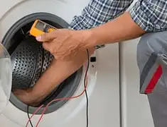 Washing machine repair technician testing a front-load washer with diagnostic tools in New Haven, CT