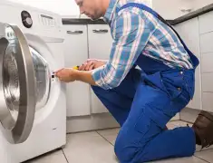 Washing machine repair technician servicing a front-load washer in New Haven, CT